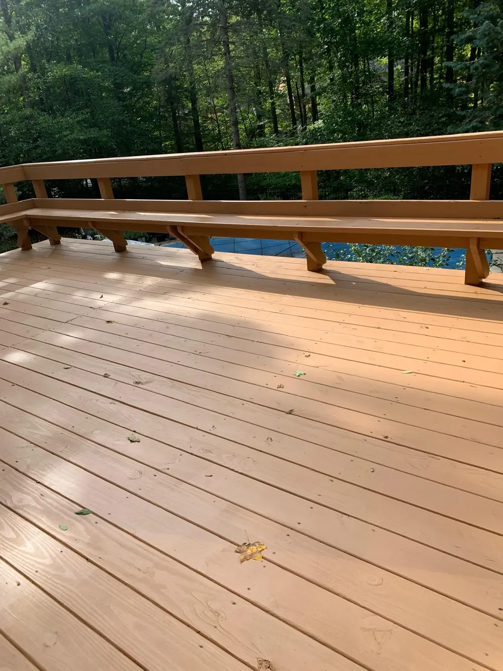 Stained wood deck overlooking the pool in Buffalo, NY