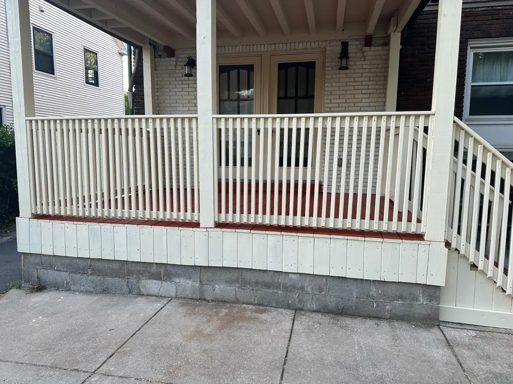 Covered front porch with cream railing in Buffalo, NY