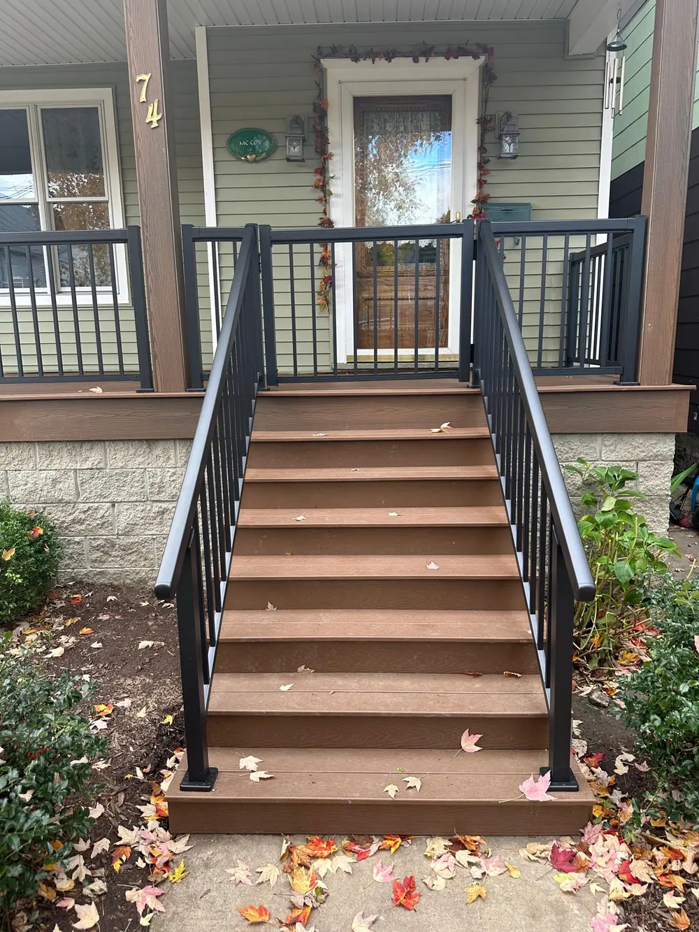 Black aluminum stair railing on new composite steps in Buffalo, NY