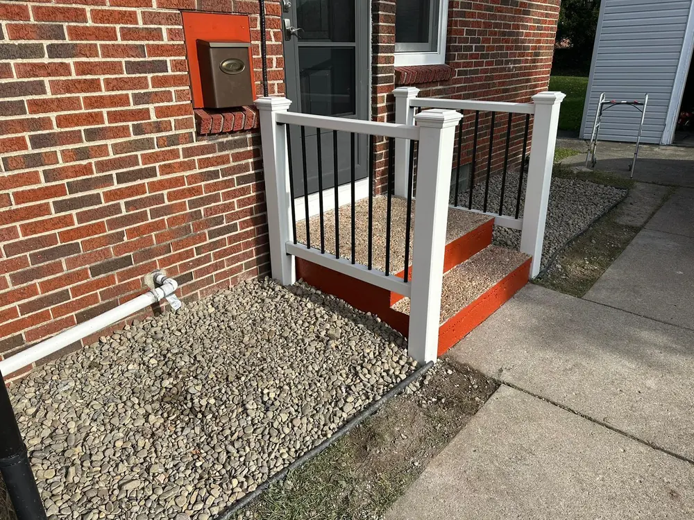 New railing above freshly painted porch steps in Buffalo, NY