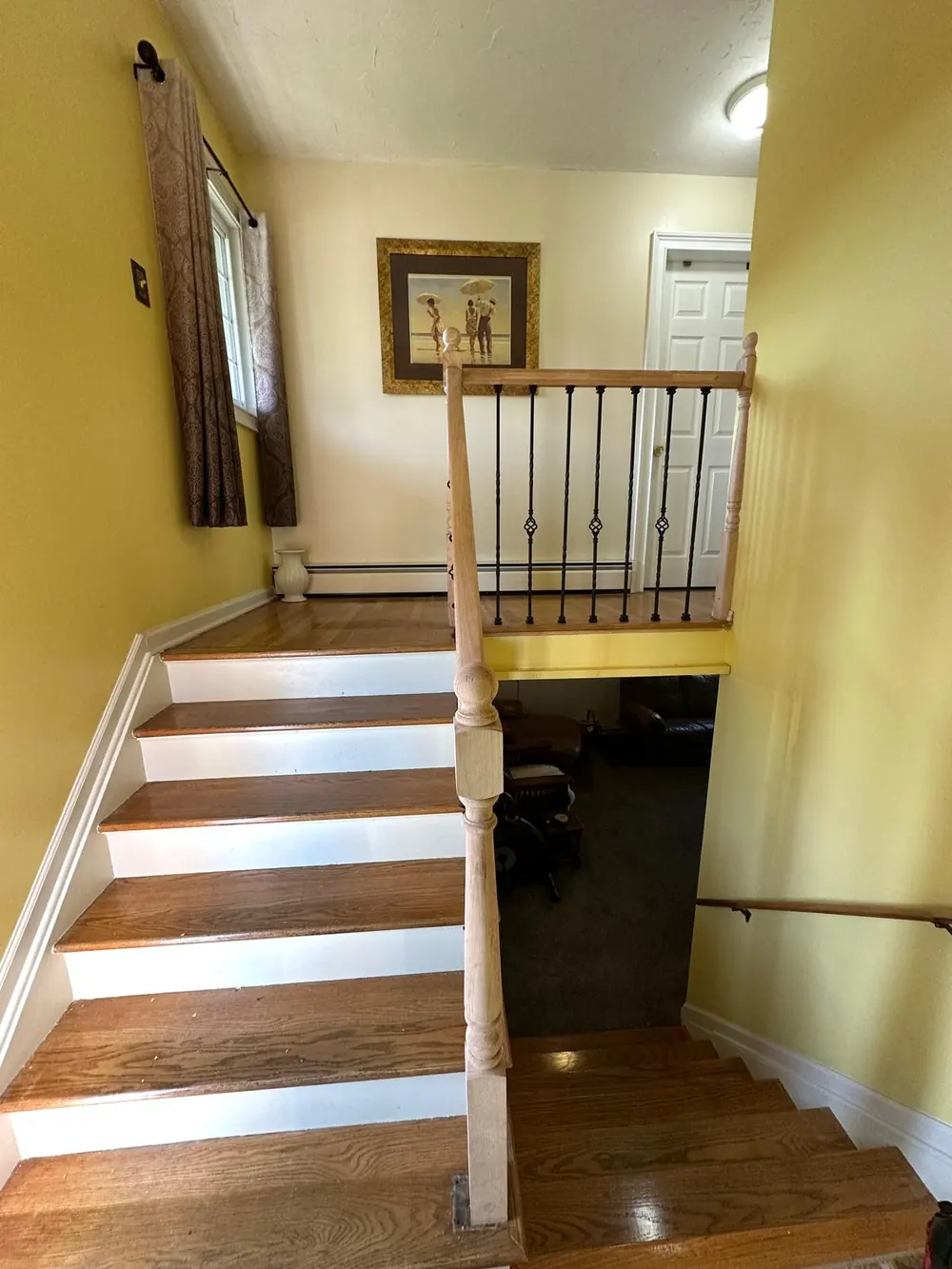 Interior staircase railing with wrought iron balusters in Buffalo, NY