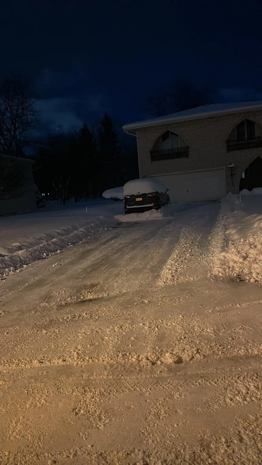 Freshly plowed driveway lit by truck headlights in Buffalo, NY