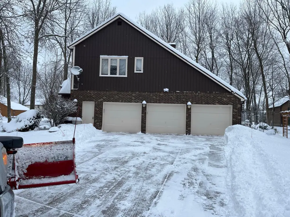 Three-car driveway cleared with tall snowbanks in Buffalo, NY