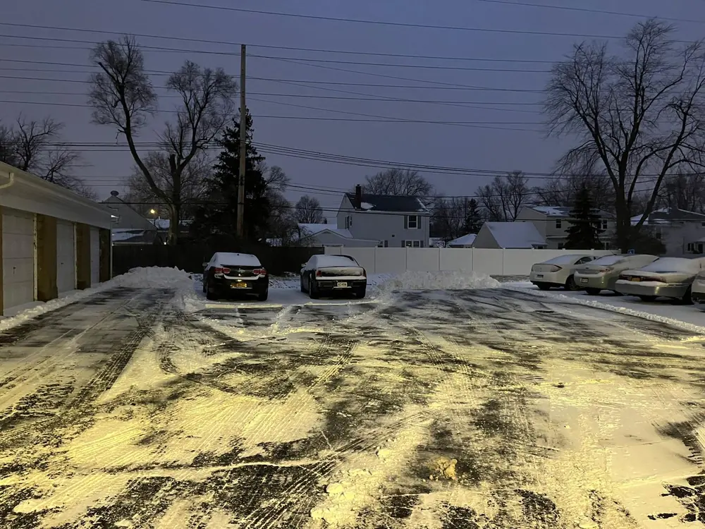 Apartment complex lot plowed clear at dusk in Buffalo, NY