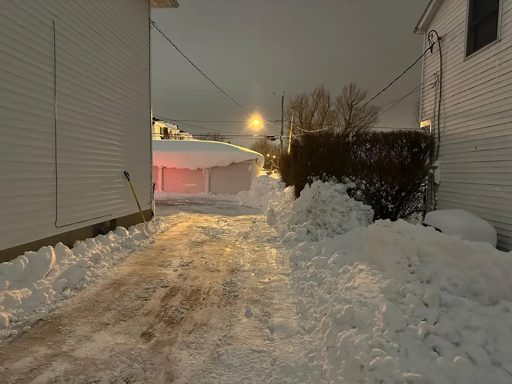 Narrow driveway cleared between houses in Buffalo, NY
