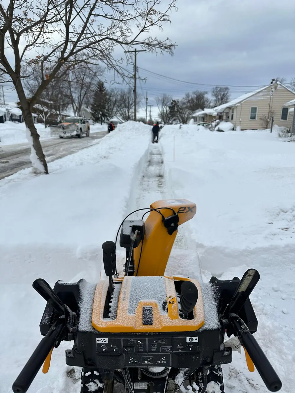 Snowblower clearing a sidewalk path in Buffalo, NY